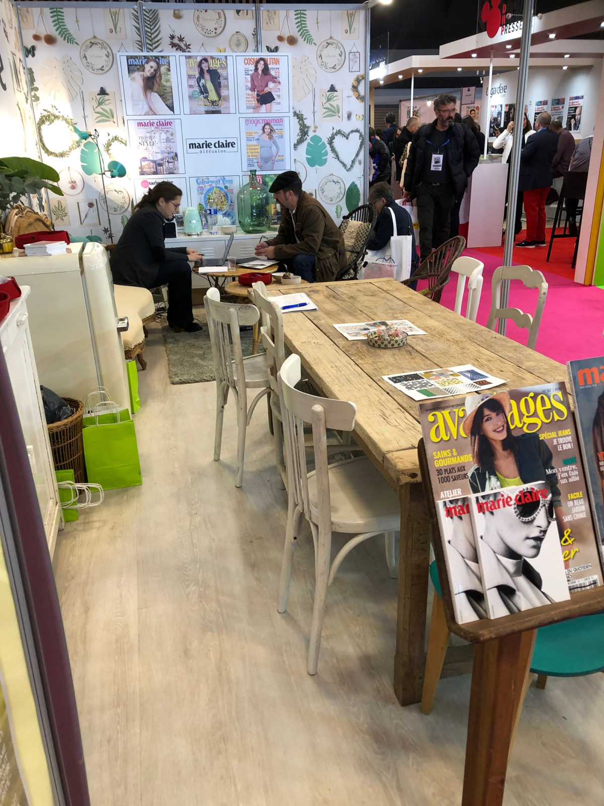 jolie mise en scène sur le satnd Marie-Claire idées, EXPOPRESSE 2019 - ambiance chaleureuse avec une grande table d'hôtes en bois patiné un papier jungle et un sol BerryAlloc.