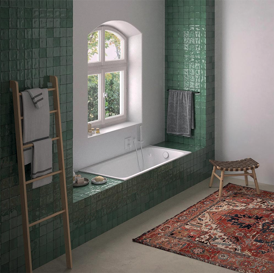 la baignoire est encastrée sous la fenêtre, dans un renfoncement mural et décorée de zelliges vert émeraude